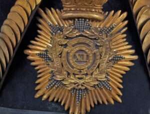 Close-up of 11th Foot Regiment cap badge